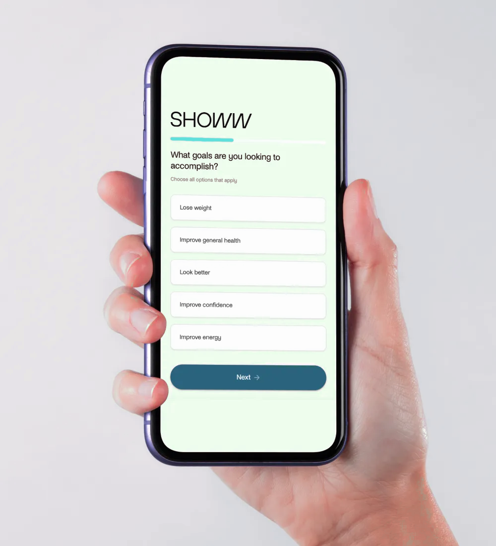 A hand holding an iPhone with the SHOWW app on the screen.